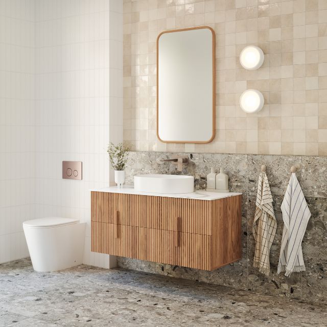 Bao Elegant Matte White Rimless Toilet Suite with behind the wall cistern featuring Nero flush plate and buttons in Brushed Bronze in Warm Neutral bathroom