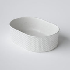 Bao Pill 500mm above counter basin in natural rough texture with diamond embossed finish. Speckled  matte white.